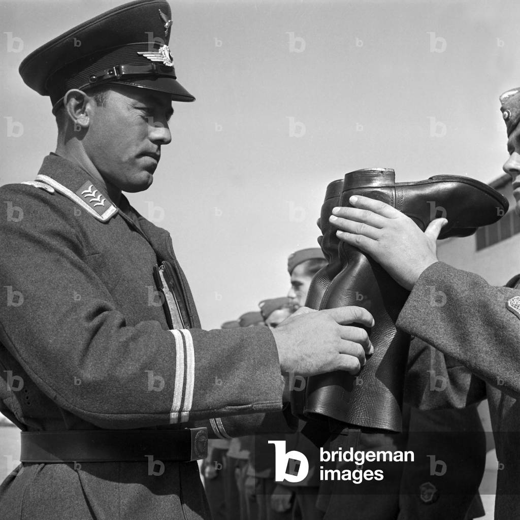 Boot mustering: kissem (staff sergeant) at his merciless control, Germany 1940s (b/w photo)