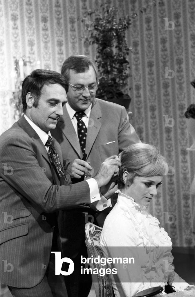 Hairdresser Dieter Haak (center) creating a lady's hairdo, Germany 1960s