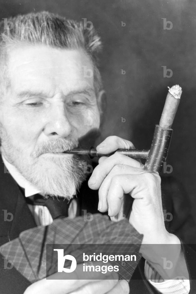 A man smoking a cigar for an advertising campaign, Germany 1930s (b/w photo)