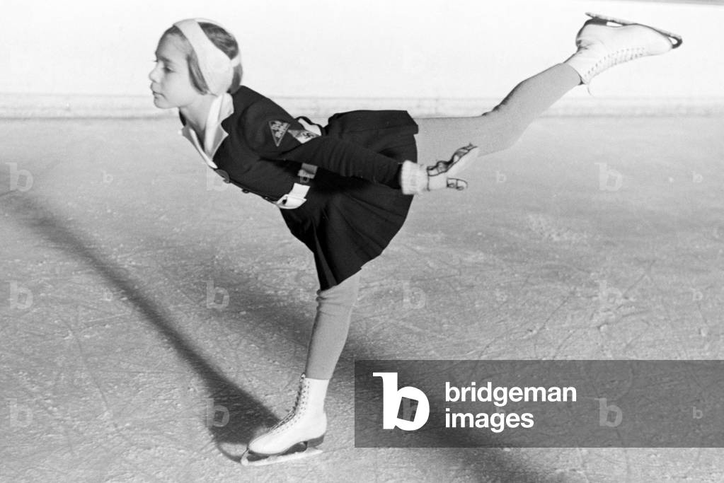 A BDM children figureskaters with the Hitler Youth patches and the swastika emblem on her clothing during a training with the Austrian figureskater and Olympics champion Karl Sch/Sfer, Germany 1930s