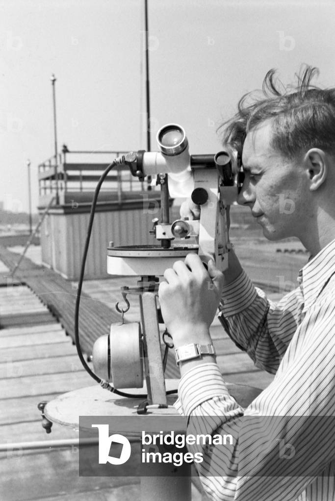 Staff member of a meteorological office calibrating analyser, Germany 1930s (b/w photo)