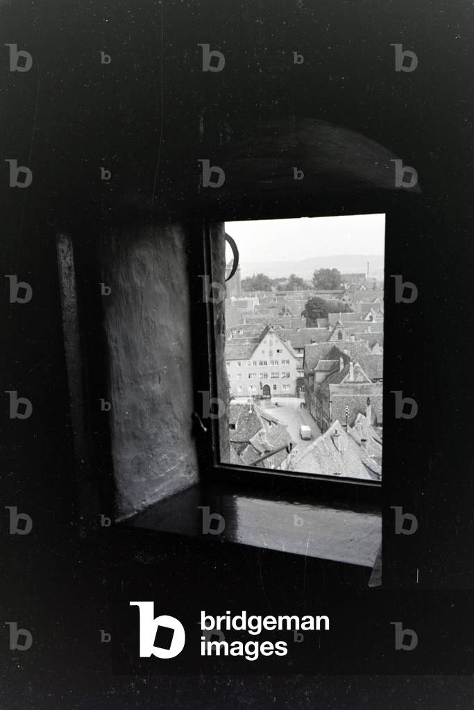 View out of a little tower window onto the many tiled roofs of the city Rothenburg ob der Tauber, Germany 1930s (b/w photo)