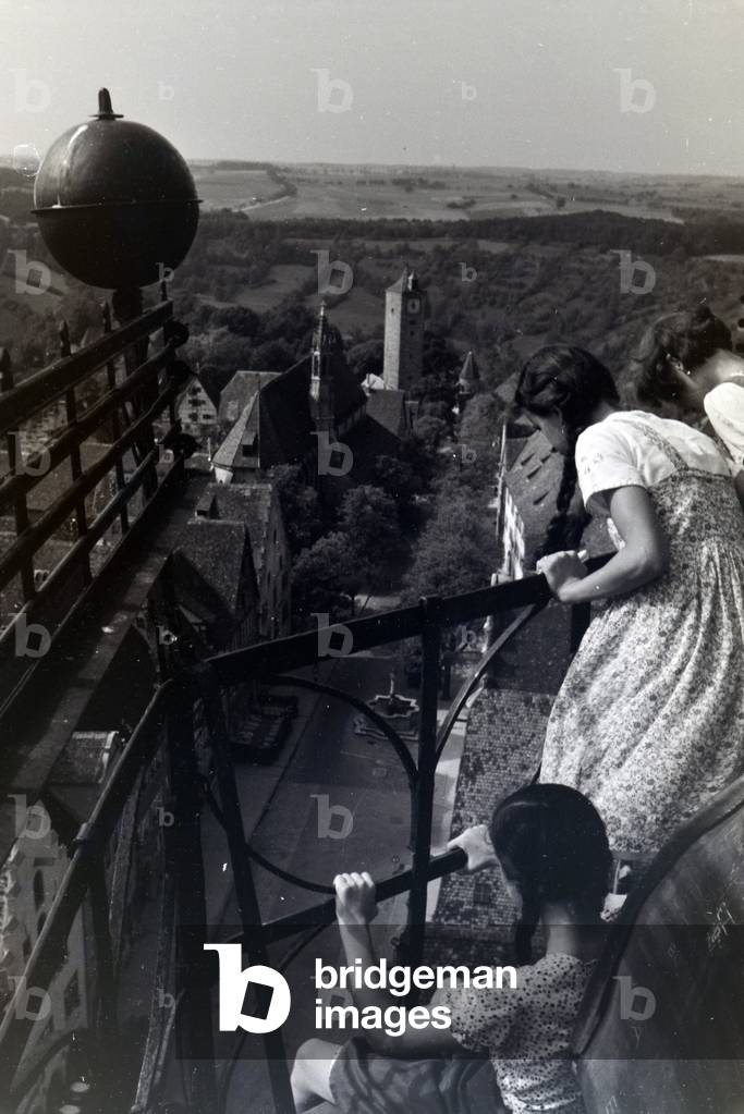The highest tower of the townhall presents an excellent view over the whole city center and the surrounding natural landscapes of Rothenburg ob der Tauber, Germany 1930s (b/w photo)