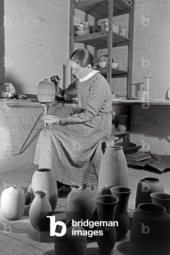 A porcelain painter at work, Germany 1930s (b/w photo)