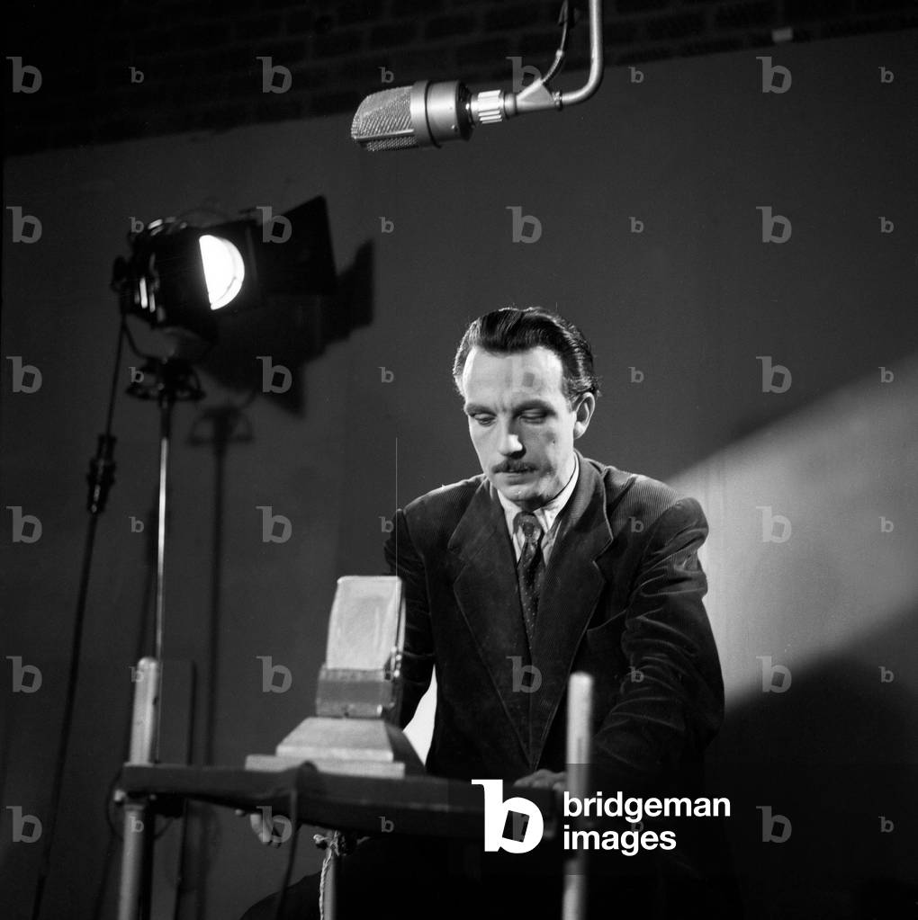 A presenter of German radio and TV station NDR preparing for his annoncement, Germany 1950s