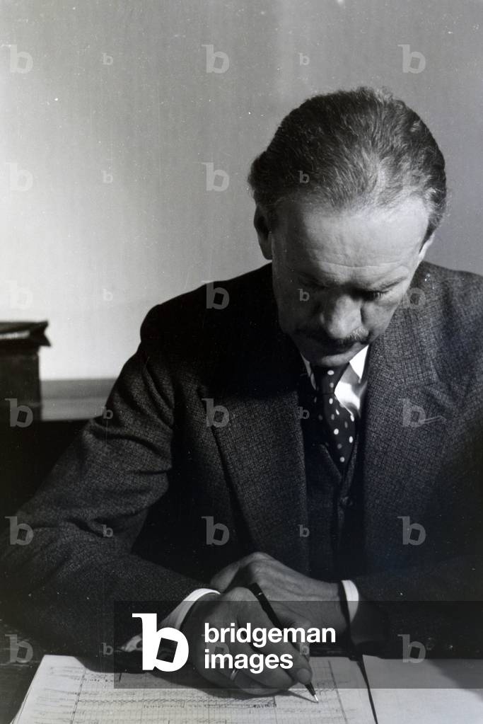 Portrait of one of the Diehl brothers and founders of the hedgehog character Mickie working on the skript of the animated movie The Race between the Rabbit and the Hedgehog, Germany 1930s (b/w photo)
