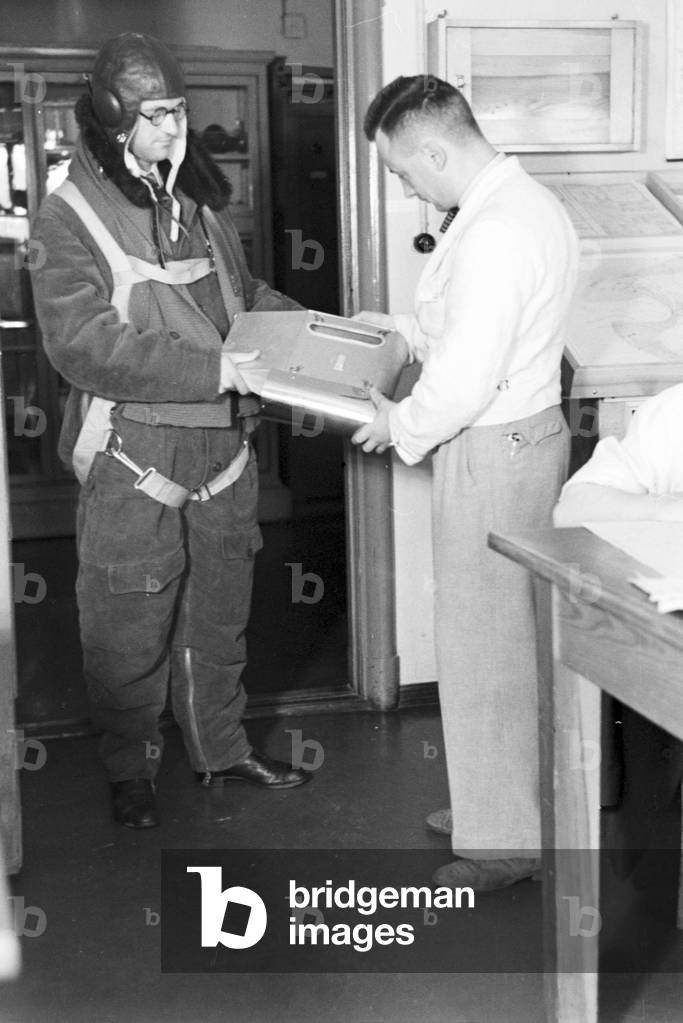 Staff member of a meteorological office before measuring the rainfall, Germany 1930s (b/w photo)