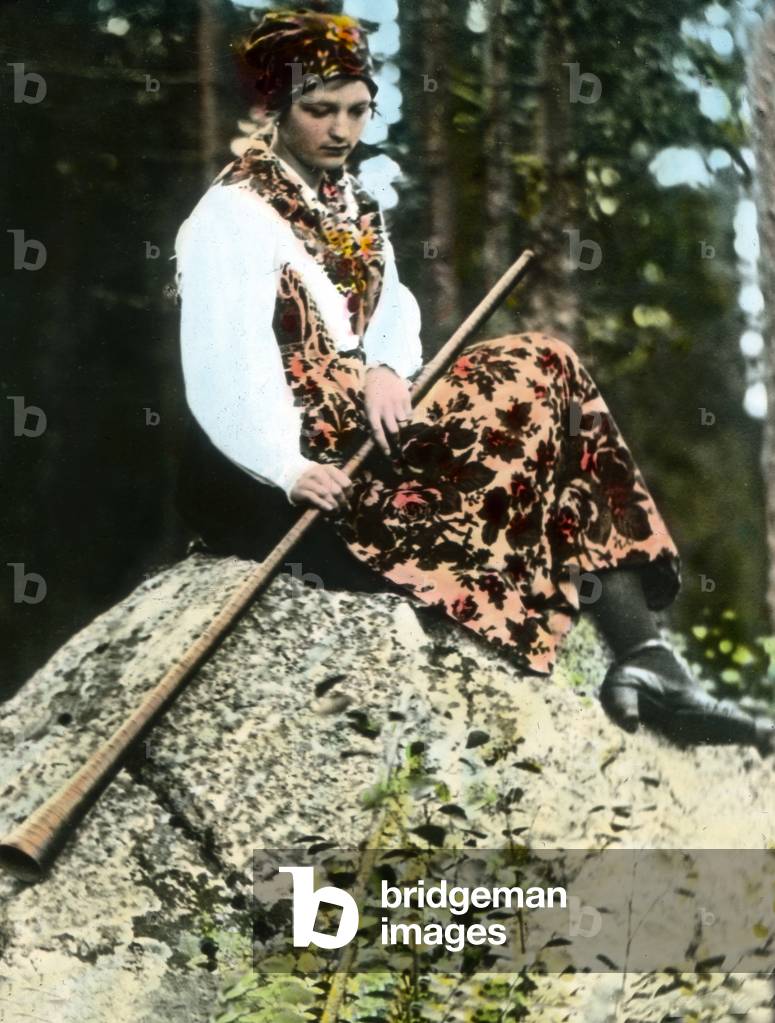 Sweden, Young herdswoman with horn instrument from Dalekarlien ( Dalarna ). Image date: circa 1920. Carl Simon Archive
