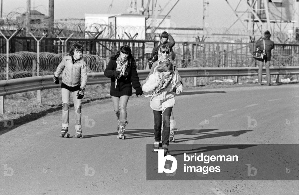 Children with roller skates at the fence of Brokdorf nuclear plant, Germany 1980s