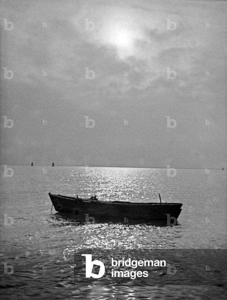 A fisherman's boat on the water of Vistula Lagoon, East Prussia, 1930s (b/w photo)