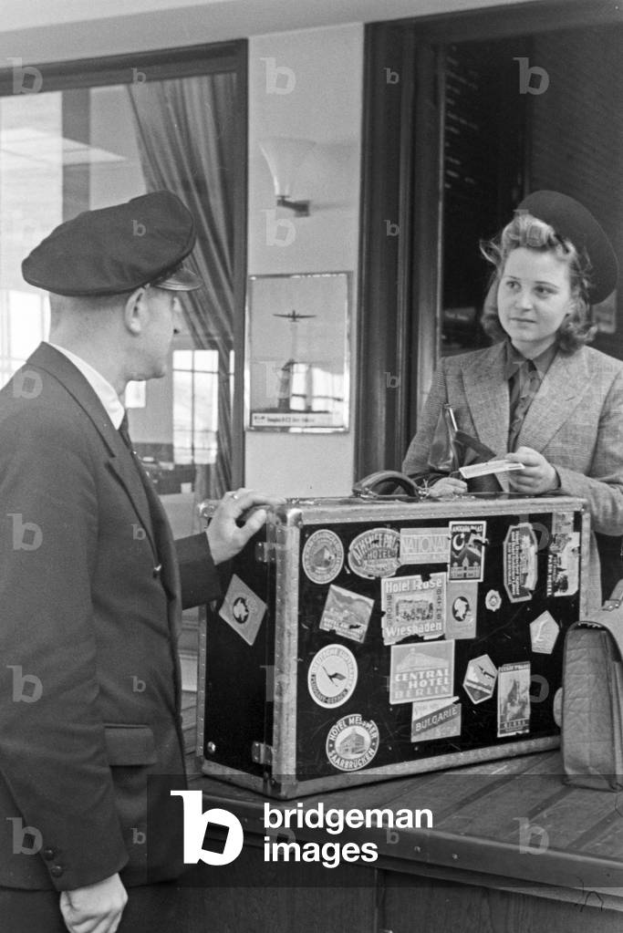 A female passenger with a customs officer at Berlin Tempelhof airport, Germany 1930s (b/w photo)