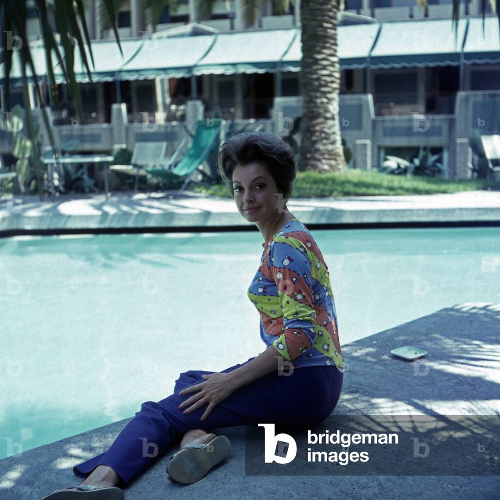 German actress Nadja Tiller at a swimming pool, Italy 1960s