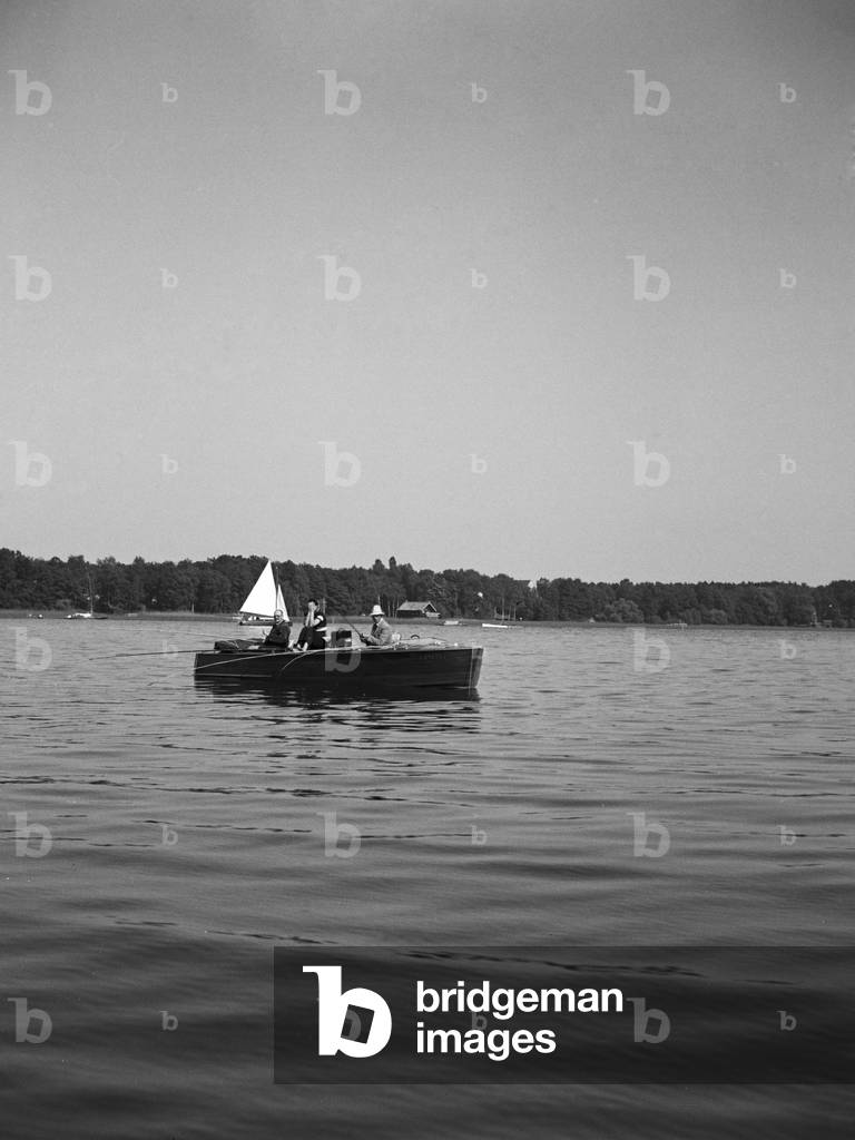 A man on a lake in his motor boar, Germany 1930s (b/w photo)