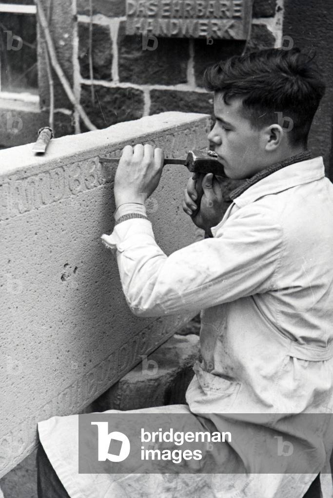 Trainee of a chiseller school at a tutorial, Germany 1937 (b/w photo)
