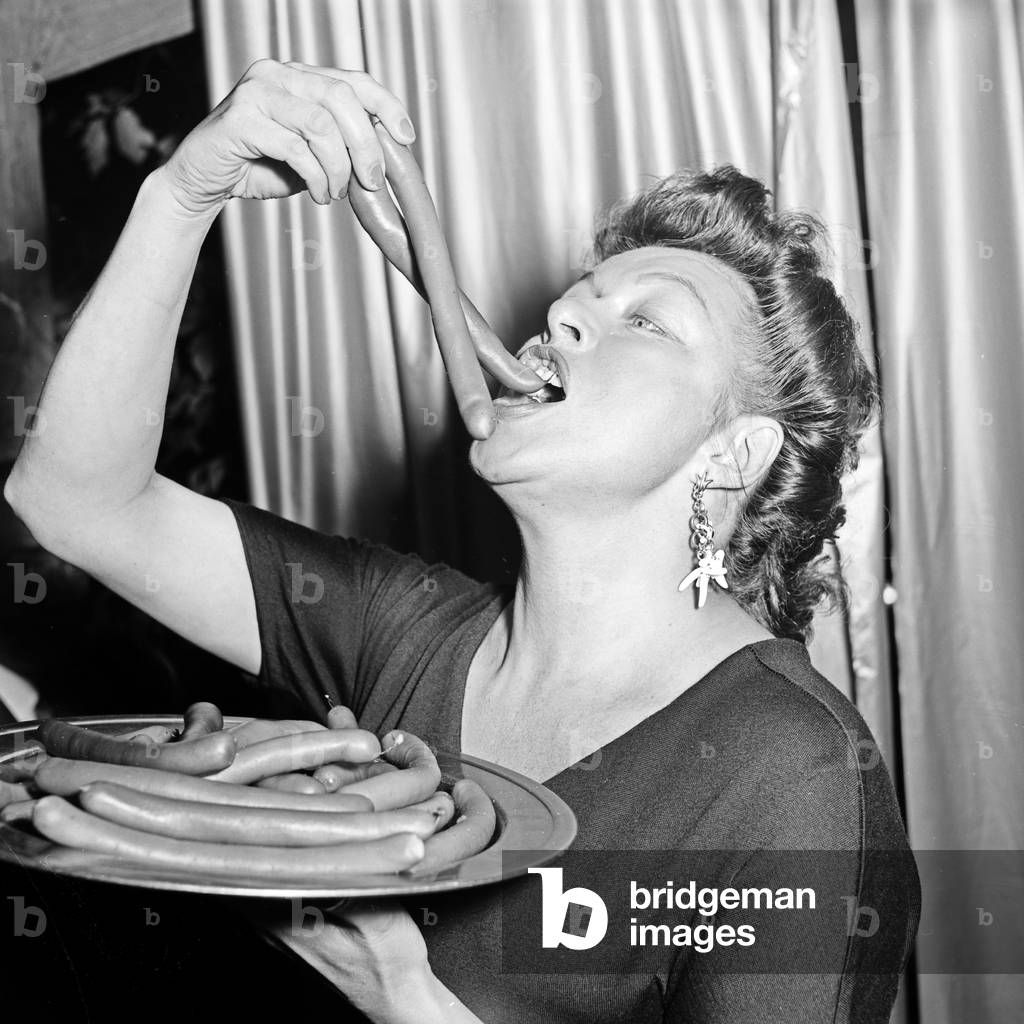 German actress Lotte Rausch eating some Wieners, Germany 1950s