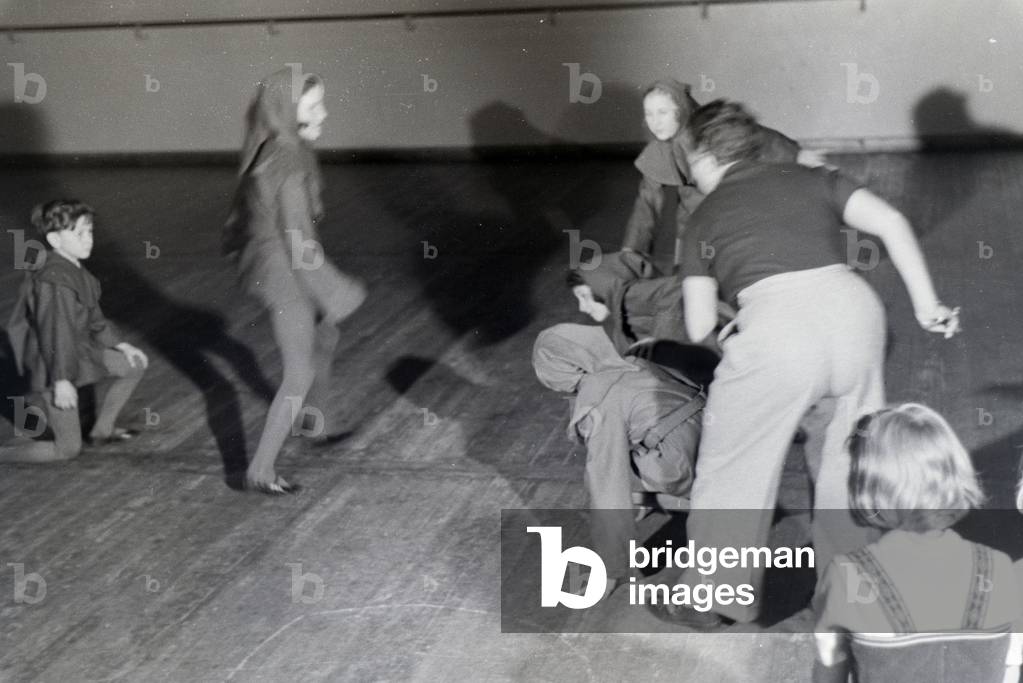 Teacher with disguised Children at the rehearsal of a dance or a play, Germany 1930s (b/w photo)