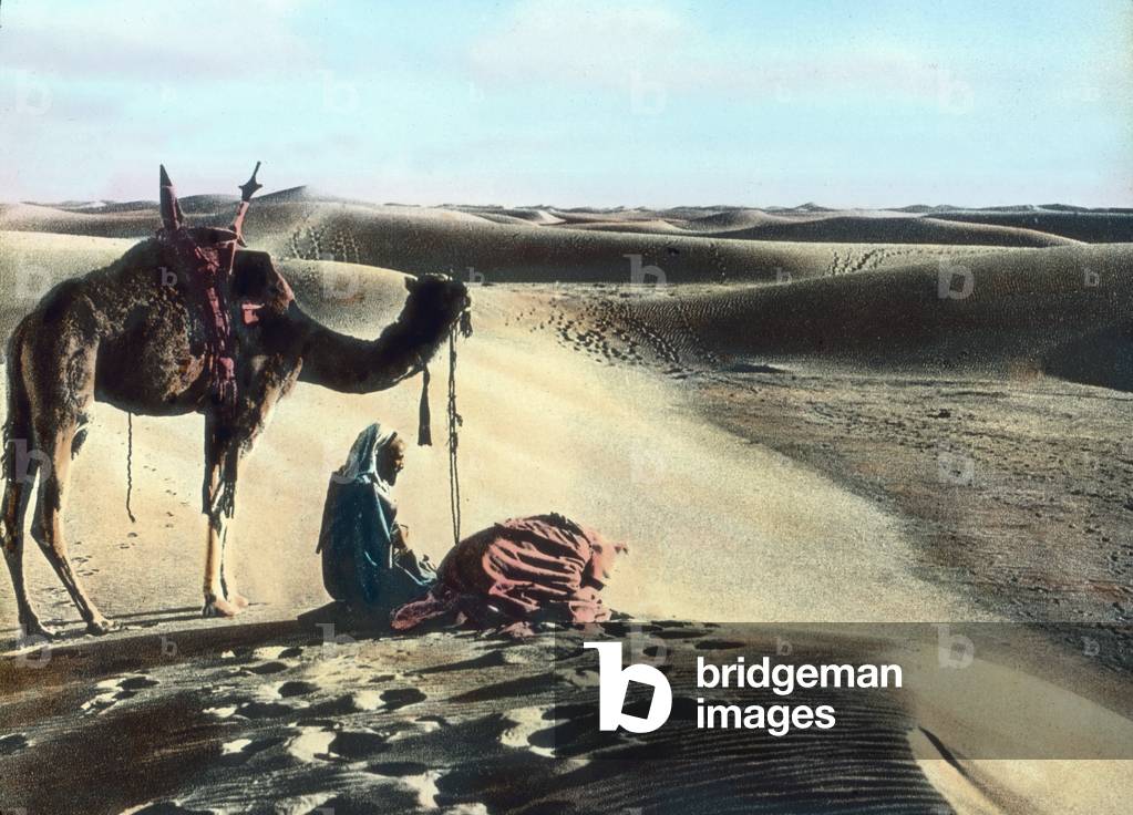 Morocco, praying Muslims in the desert, image date: circa 1910. Carl Simon Archive