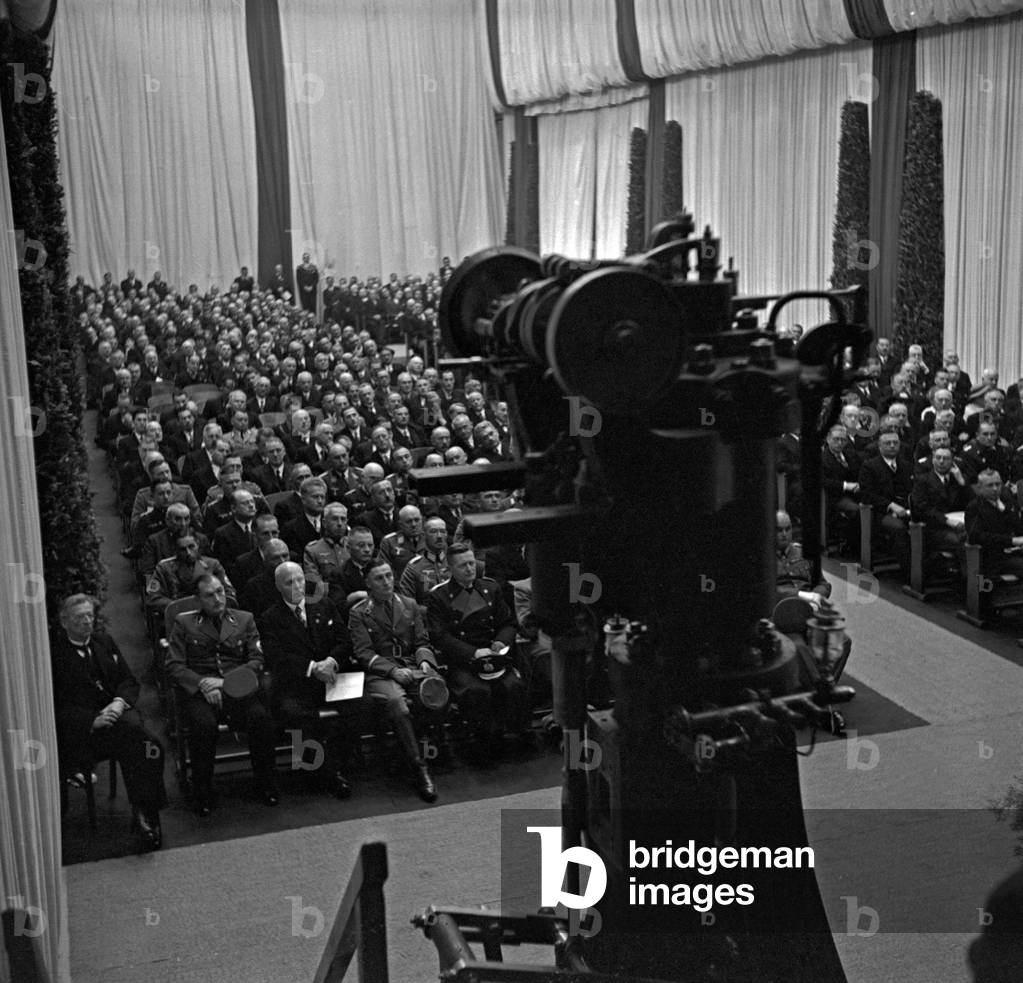 An audience listening to a speech at a Diesel anniversary at the MAN factory Augsburg, Germany 1930s (b/w photo)