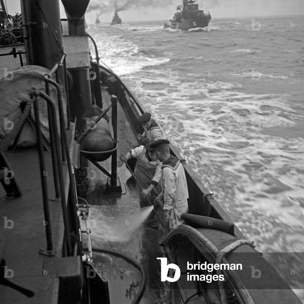 Navy recruits of the 2nd minesweeper flotilla swabbing the deck, Germany 1930s (b/w photo)