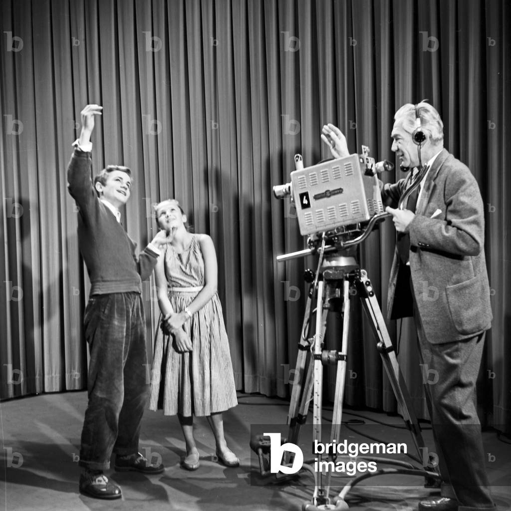 A young man explaing the effects of light incidences in front of a camera, Germany 1950s