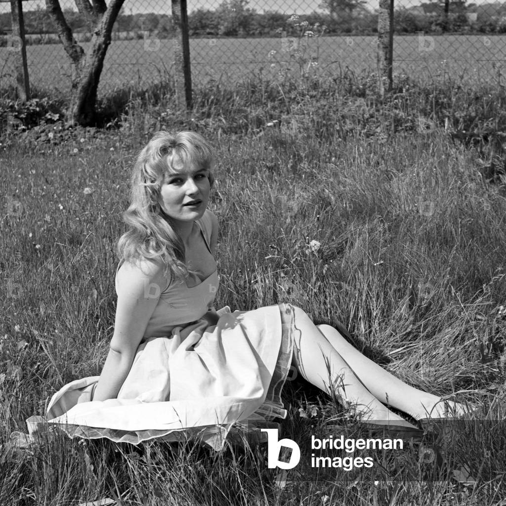 German actress Karin Stoltenfeldt posing in the garden, Germany 1950s