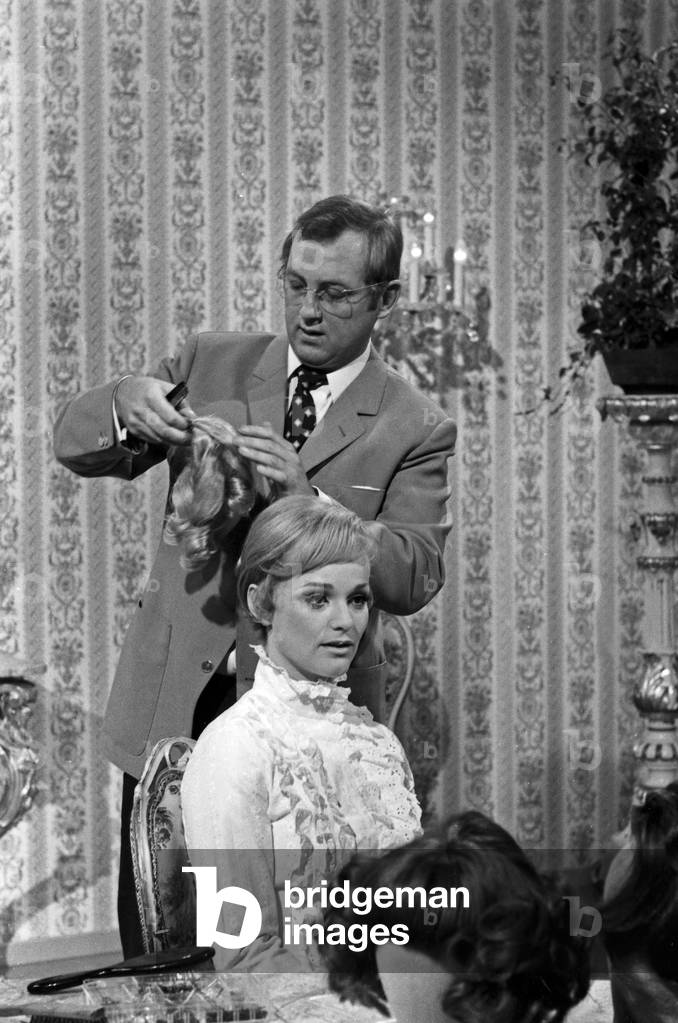 Hairdresser Dieter Haak creating a lady's hairdo, Germany 1960s