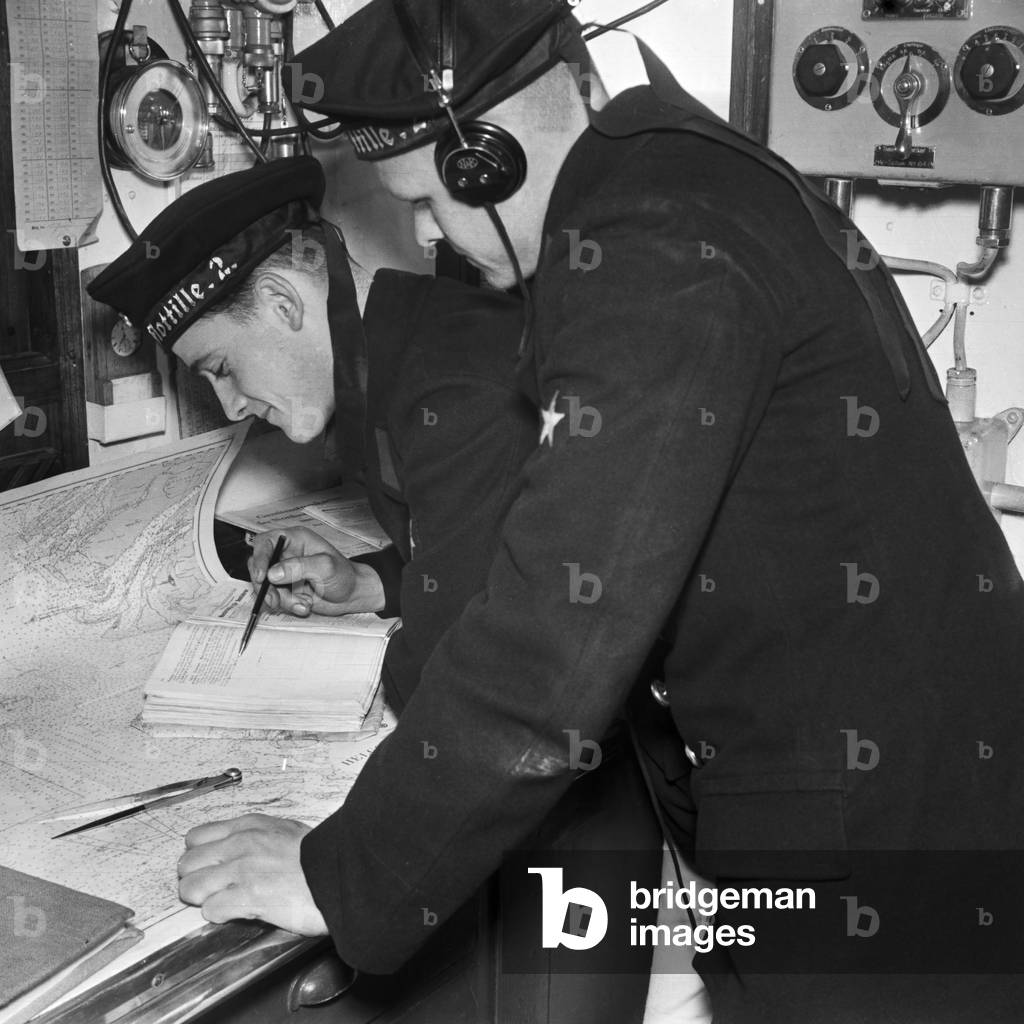Radio sailor an navigating sailor of a minesweeper at an exercise on his mindsweeper, Germany 1930s (b/w photo)