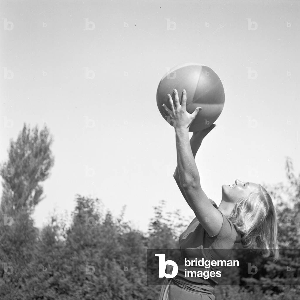 A young woman with a beachball, Germany 1930s (b/w photo)