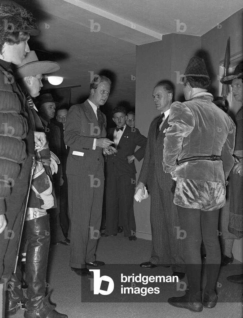 A music crew around a musician at the broadcasting building in Berlin, Germany 1930s (b/w photo)
