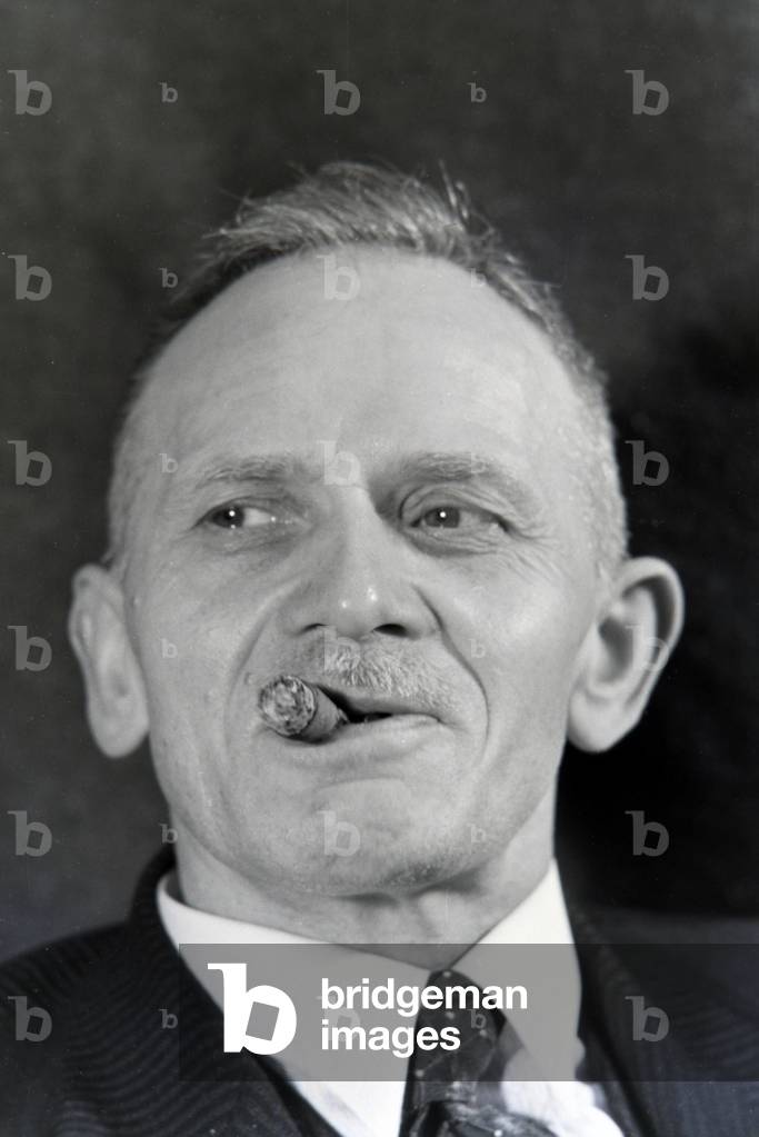 A man smoking a cigar for an advertising campaign, Germany 1930s (b/w photo)