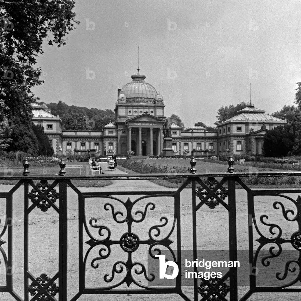 View over the railing of a fence to the Kaiser-Wilhelms-Bad at Bad Hombugr, Germany 1930s (b/w photo)