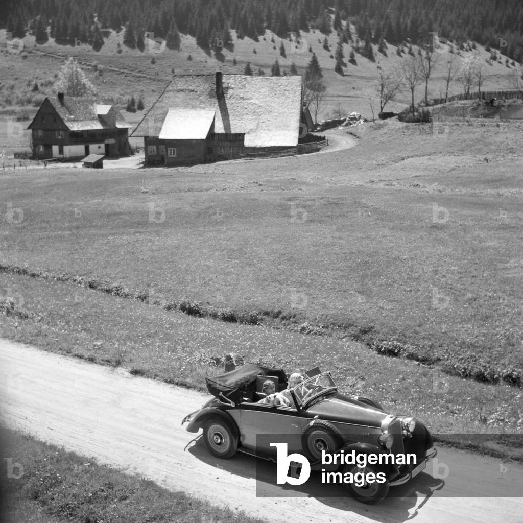 On the road in a Mercedes Benz at Black Forest region, Germany 1930s (b/w photo)