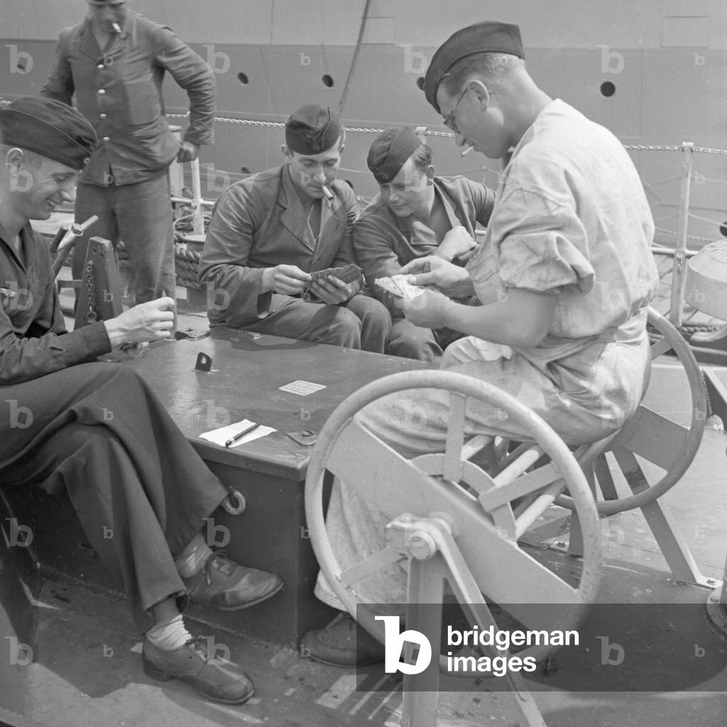 Sailor's leisure: playing cards on deck of a torpedo boat, Germany 1940s (b/w photo)