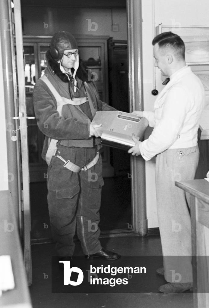 Staff member of a meteorological office before measuring the rainfall, Germany 1930s (b/w photo)