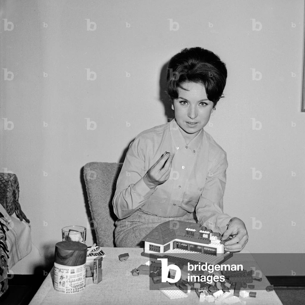 German TV speaker and presenter Brigitte Gerloff constructing a house with lego toy bricks, Germany 1960s