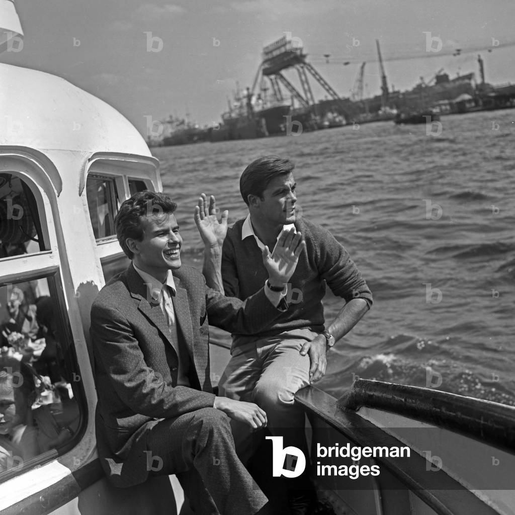 German actor Horst Buchholz and Austrian ski racer Toni Sailer on a ship at Hamburg, Germany 1950s