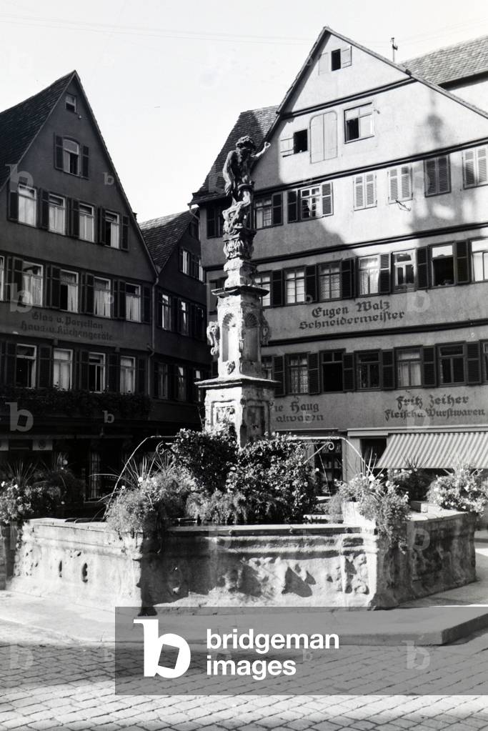 The Neptun fountain decorated with flowers on the market square of Tübingen, Germany 1930s (b/w photo)