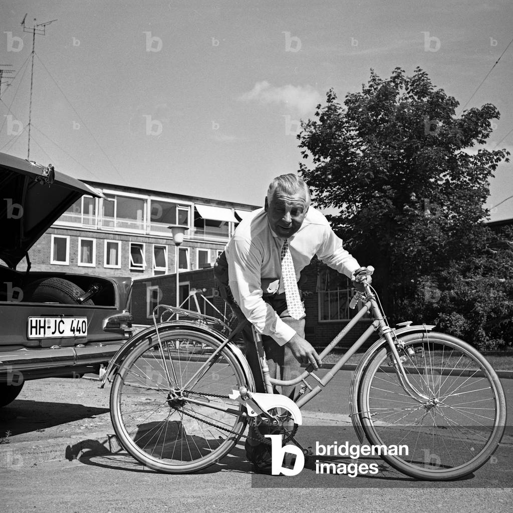 German manager and founder of TV lottery, Jochen Richert, relaxing while riding his bicycle, Germany 1960s