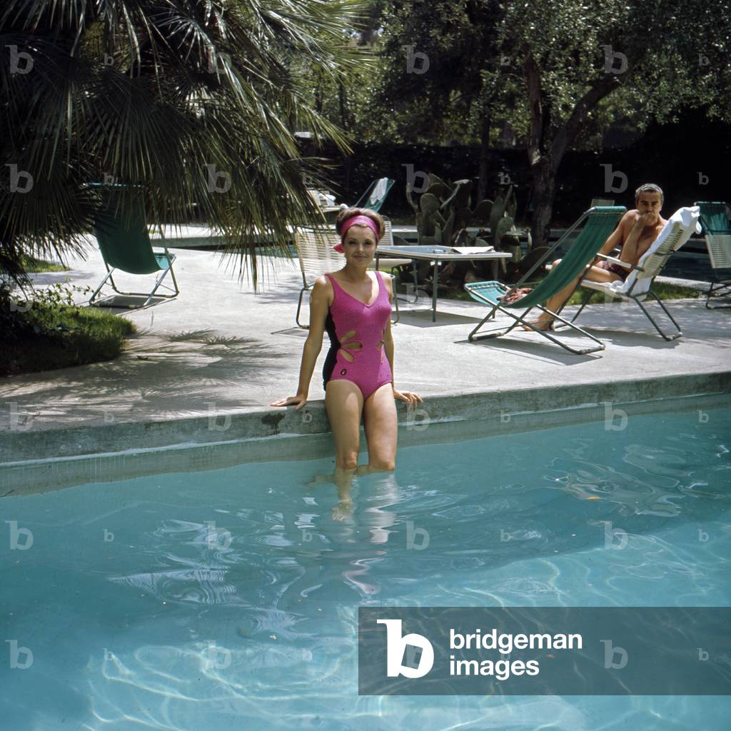 German actress Nadje Tiller in a swimsuit at a swimming pool, Italy 1960s