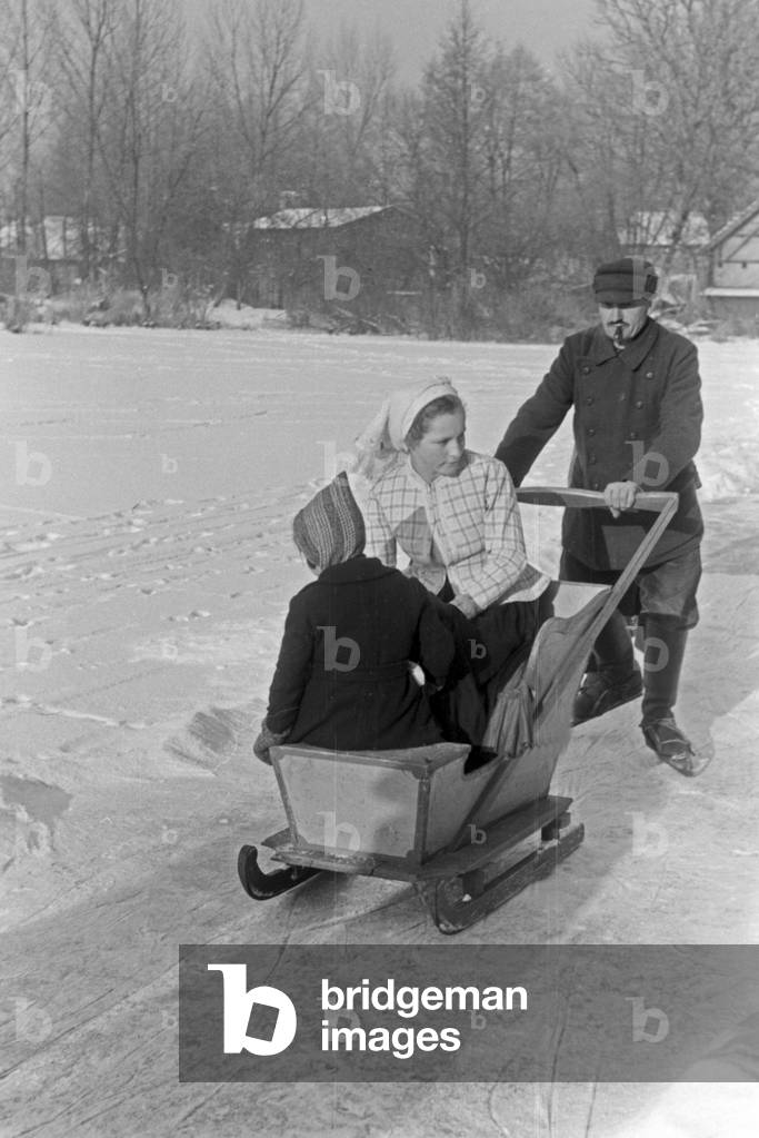 A family skating on a frozen lake at Spreewald area, Germany 1930s (b/w photo)