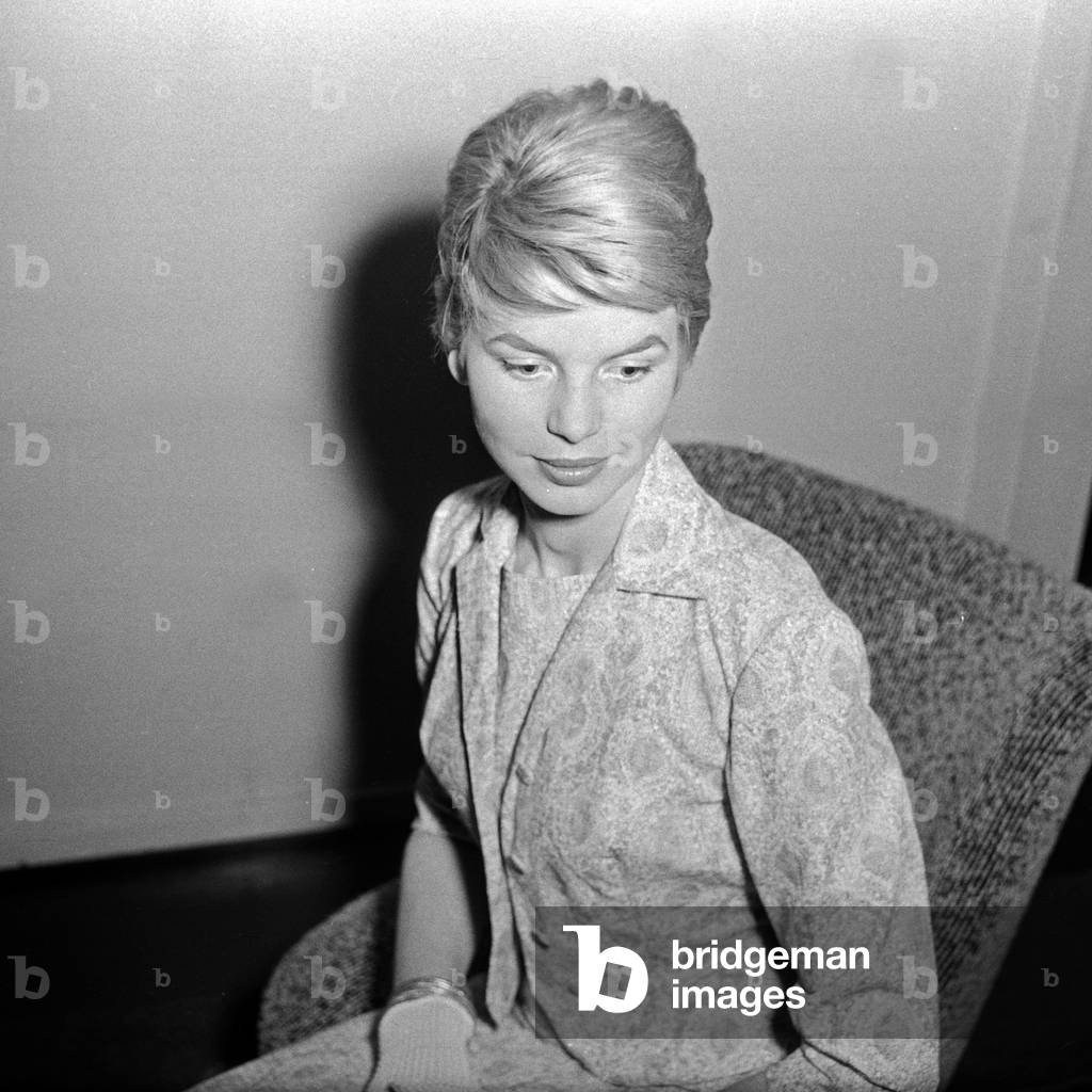 A young woman wearing gloves and nice dress, Germany 1950s