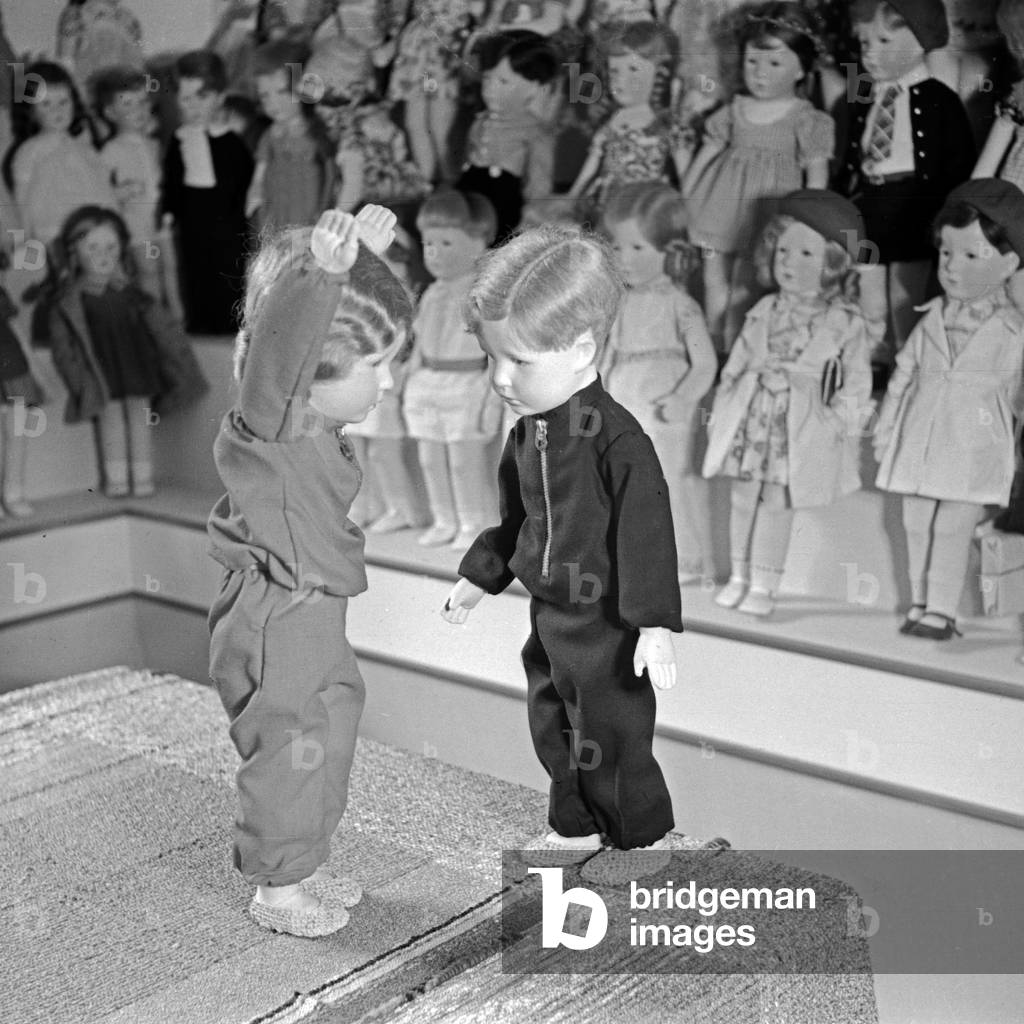 The famous Kaethe Kruse dolls, two of them in a training suit, Germany 1930s (b/w photo)