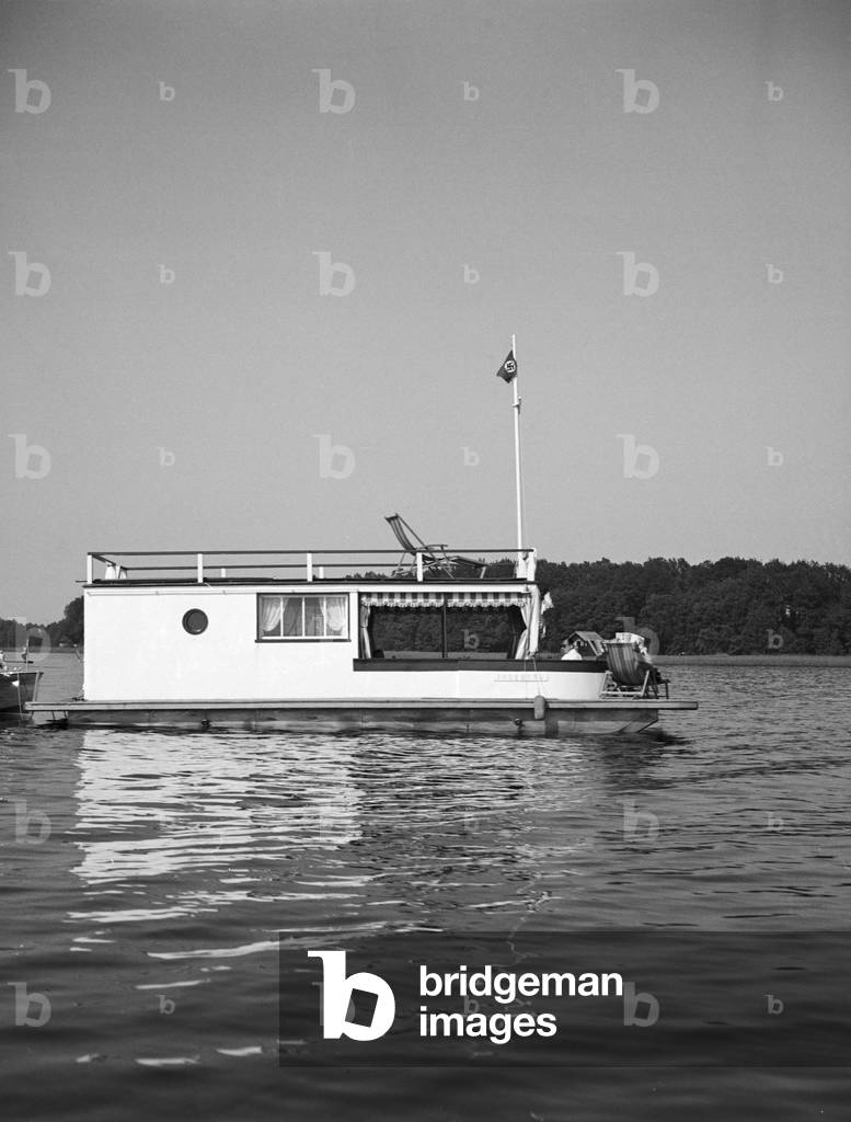 A man on a lake in his motor boar, Germany 1930s (b/w photo)