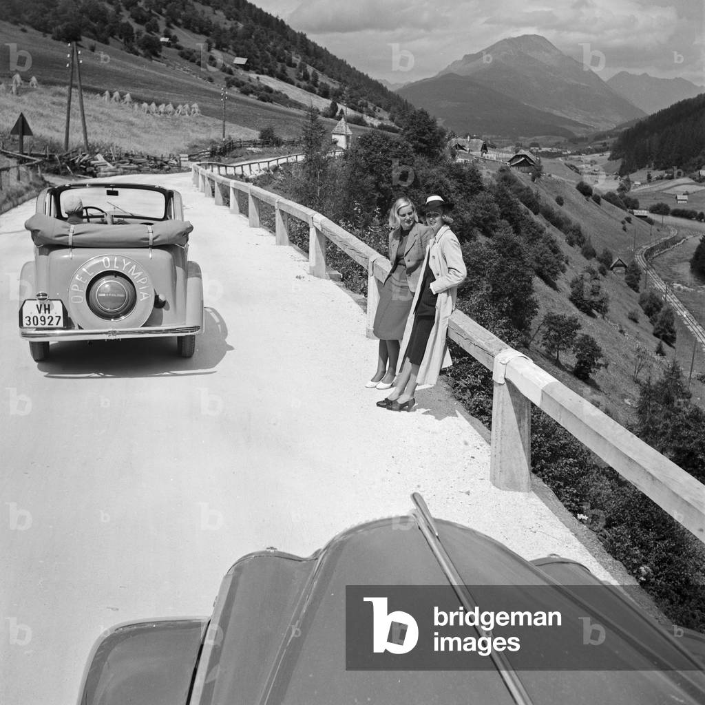 On the road with two Opel models Olympia at the Wachau area in Austria, Germany 1930s (b/w photo)