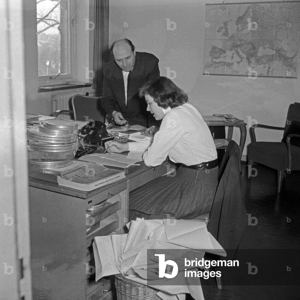Workaday life at German TV and radio station NDR: an editor at the office with his assistant, Germany 1950s