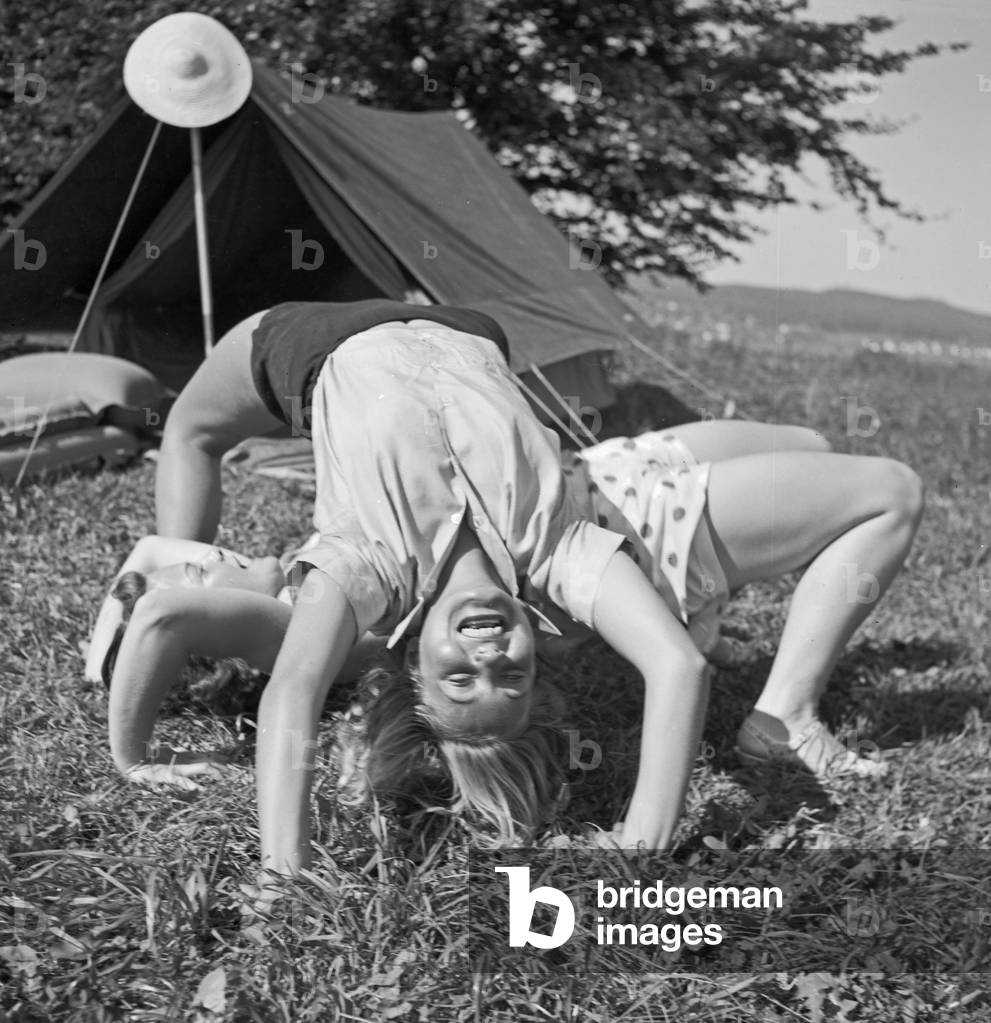 Young woman by their tent on summer vacation, Germany 1930s (b/w photo)