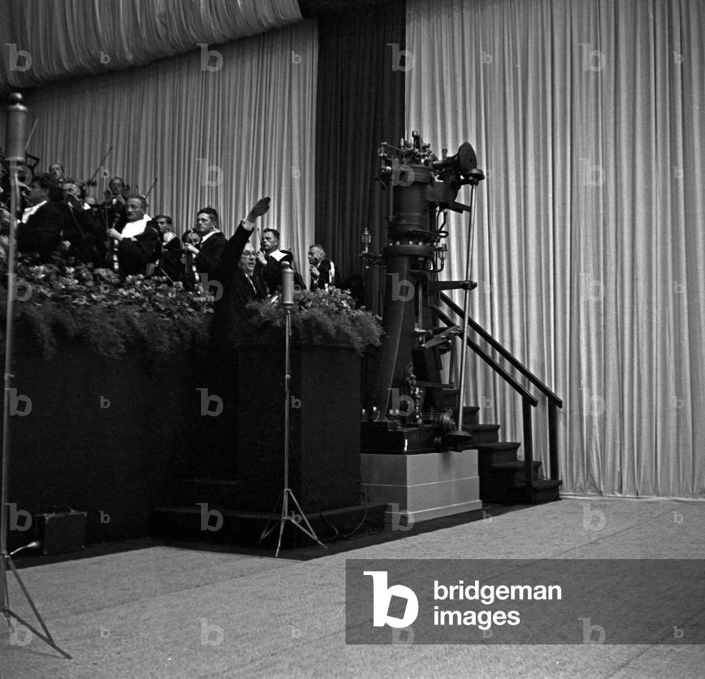 After finishing his speech the orator greets the audience with the Hitlergruss at the MAN factory Augsburg, Germany 1930s (b/w photo)