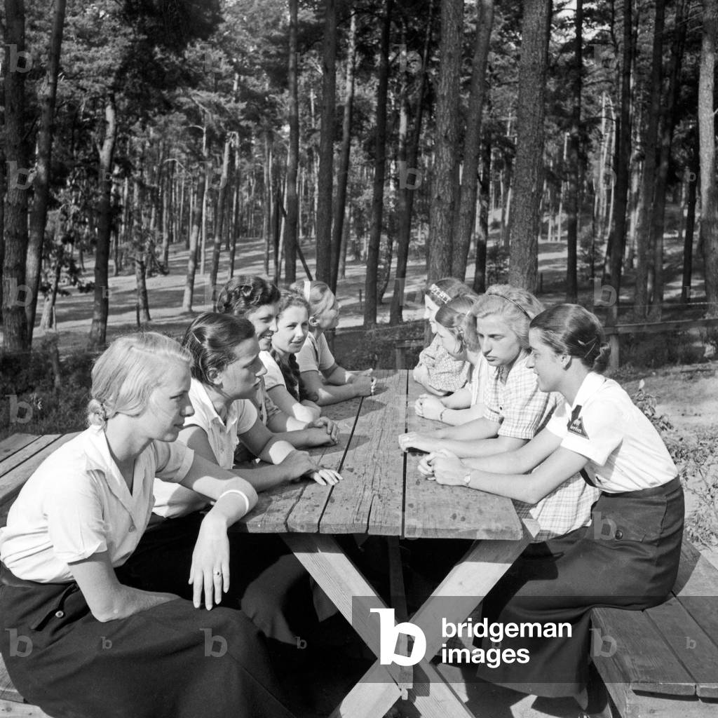A group of BDM girls sitting in the sun at leisure camp of Deutsche Arbeitsfront at Altenhof, Brandenburg, 1930s (b/w photo)