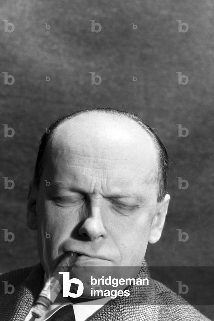 A man smoking a cigar for an advertising campaign, Germany 1930s (b/w photo)