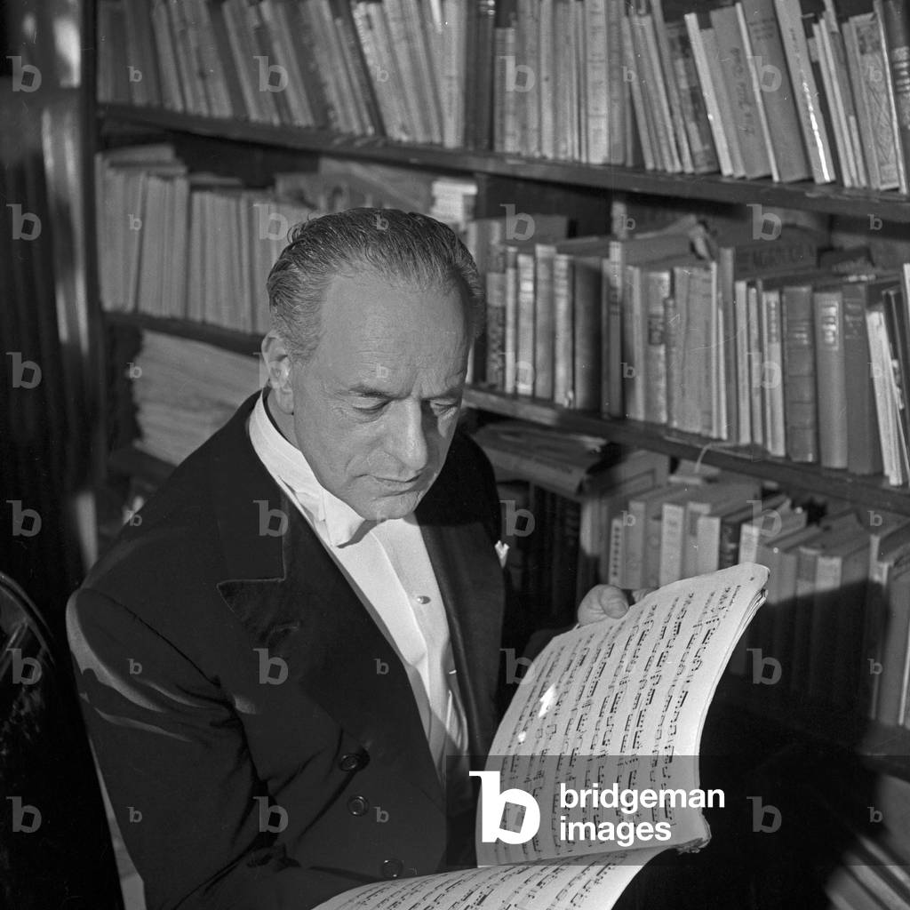 A cello player reading a music book at Hamburg, Germany 1960s